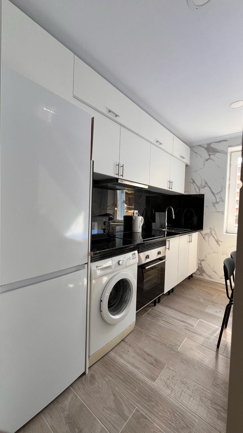 Kitchen or kitchenette, oven, stove, washing machine