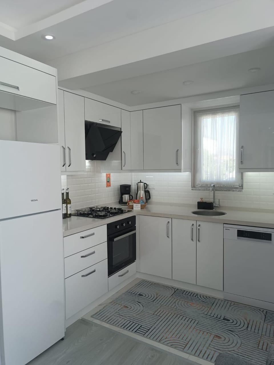 Kitchen or kitchenette, dishwasher, oven, stove