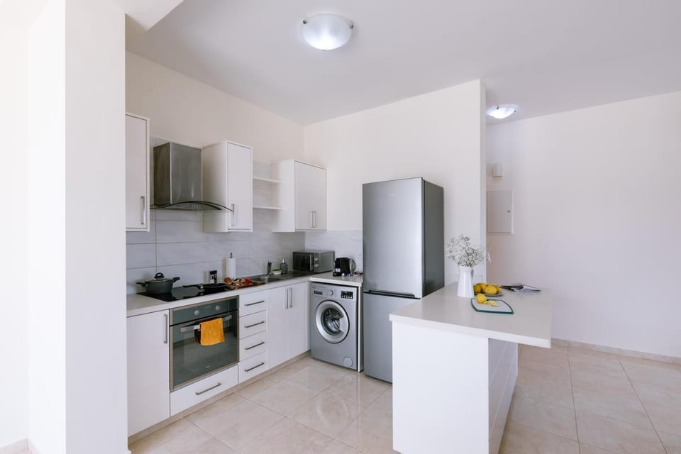 Kitchen or kitchenette, oven, stove, washing machine