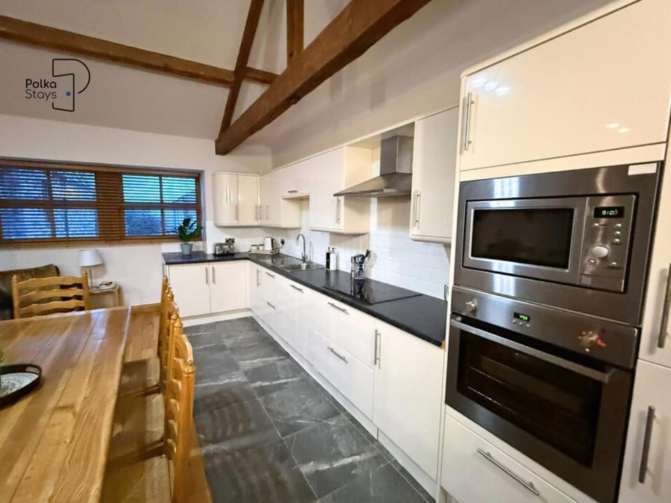 microwave, oven, stove, towels, kitchen