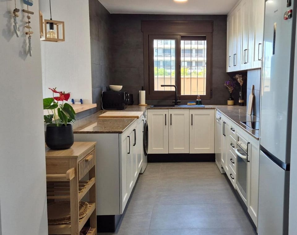 Kitchen or kitchenette, dishwasher, oven, stove
