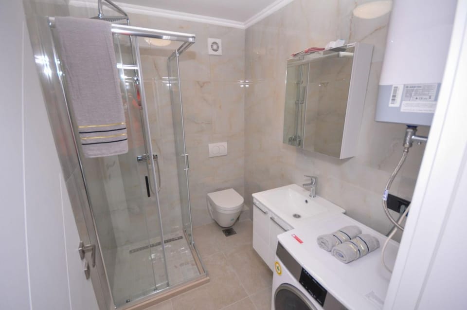 Shower, Toilet, towels, washing machine, dryer