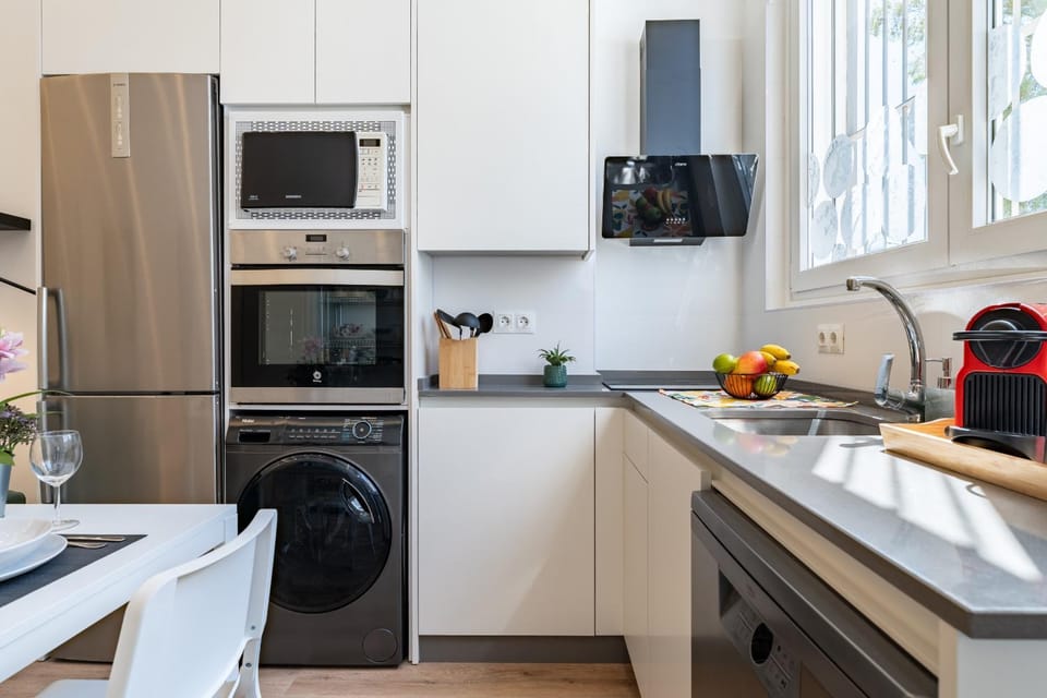 Kitchen or kitchenette, dishwasher, microwave, oven, stove, toaster, washing machine