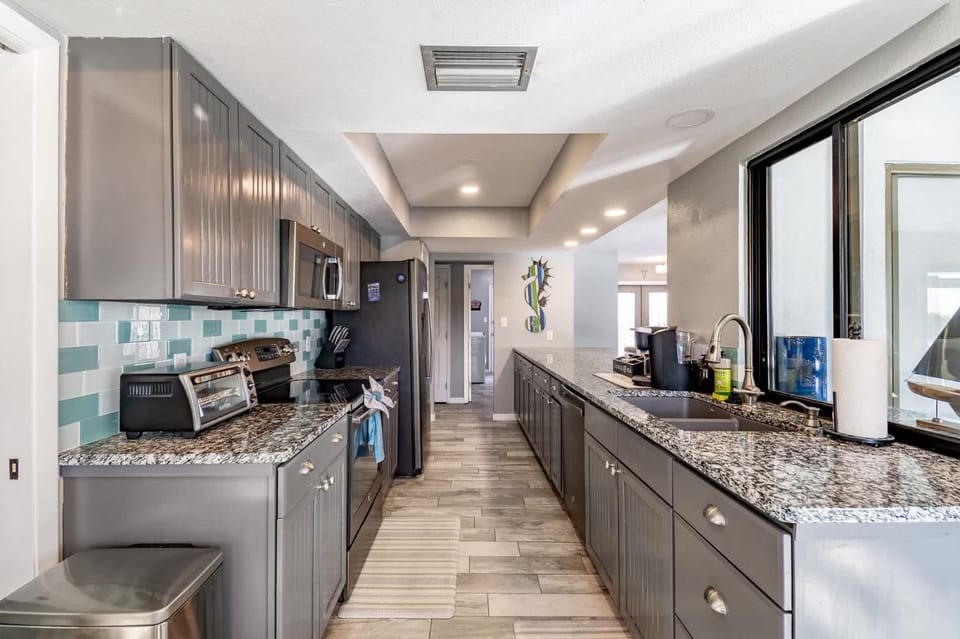 Kitchen or kitchenette, dishwasher, oven, stove, toaster