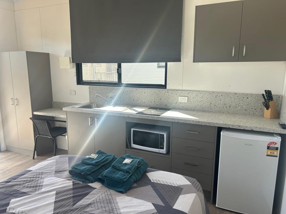 Kitchen or kitchenette, stove, towels, wardrobe