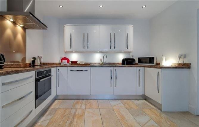 Kitchen or kitchenette, dishwasher, oven, stove, toaster
