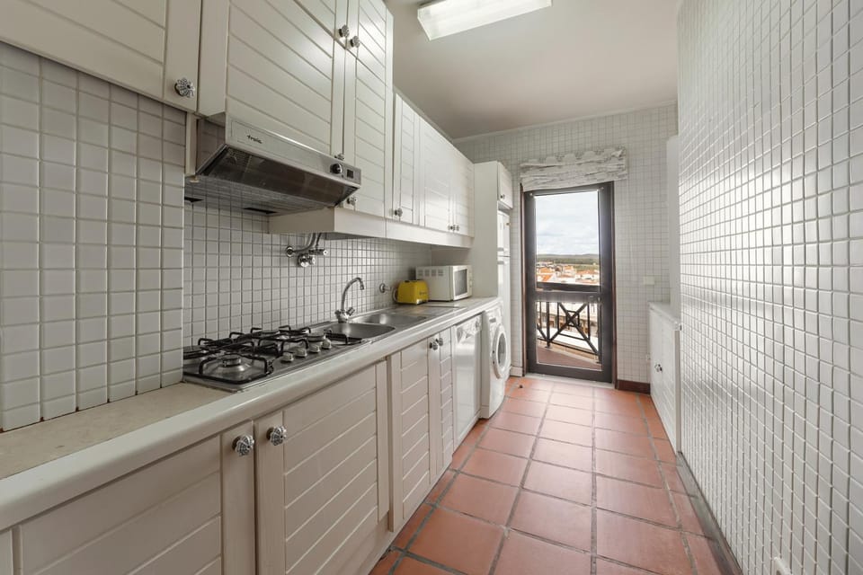Kitchen or kitchenette, dishwasher, stove, toaster, washing machine