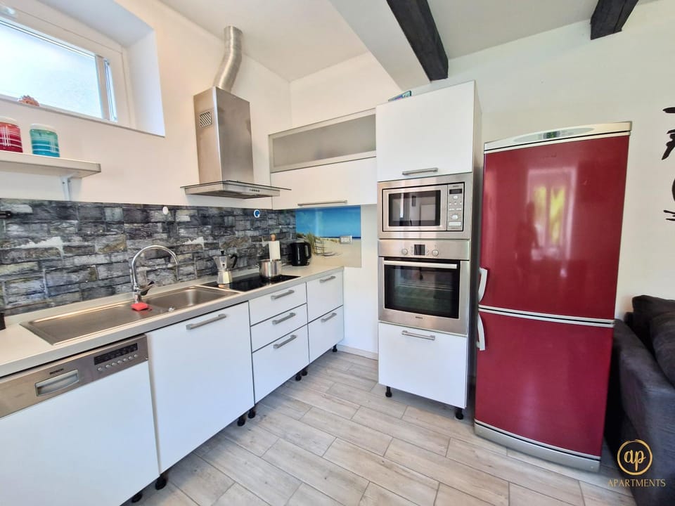 Kitchen or kitchenette, dishwasher, oven, stove