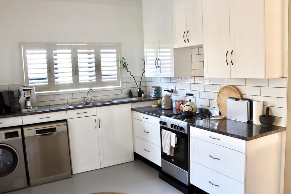 Kitchen or kitchenette, dishwasher, oven, stove, toaster, washing machine