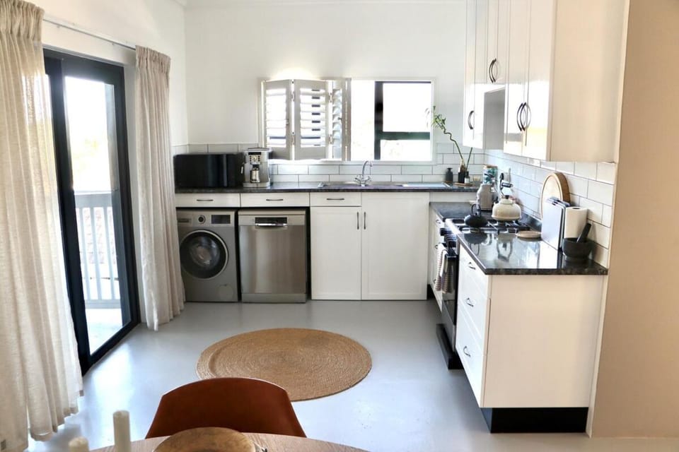 Kitchen or kitchenette, dishwasher, oven, stove, toaster, washing machine