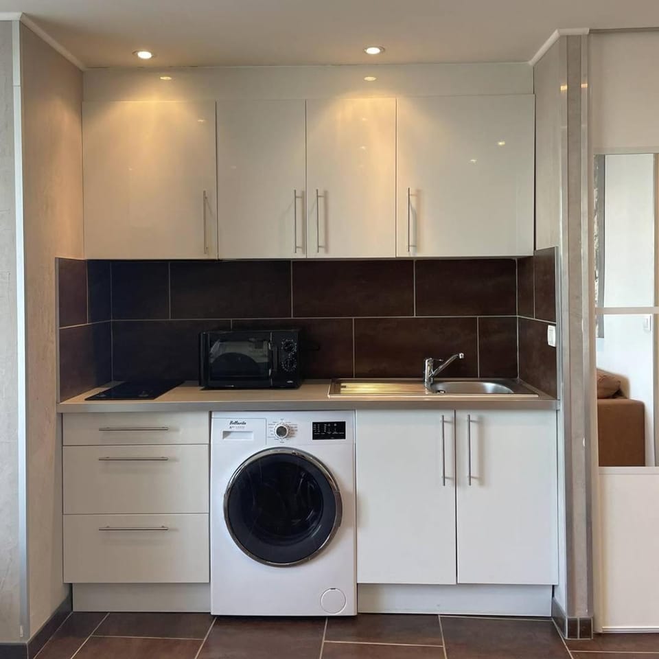 Kitchen or kitchenette, washing machine