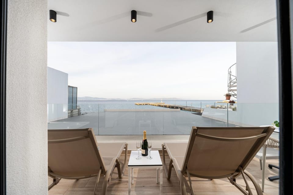 Property building, Patio, Natural landscape, View (from property/room), Balcony/Terrace, Seating area, Beach, Sea view
