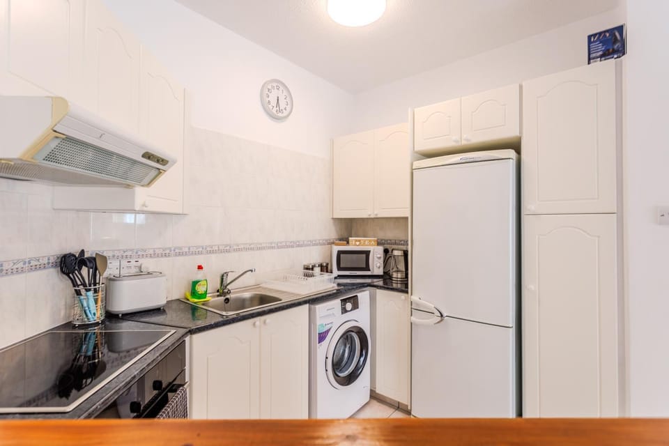 Kitchen or kitchenette, oven, stove, toaster, washing machine