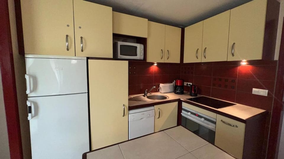 Kitchen or kitchenette, dishwasher, microwave, oven, stove