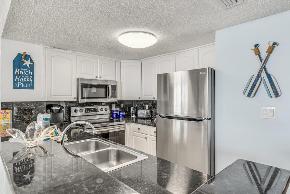 Kitchen or kitchenette, dishwasher, oven, stove, toaster