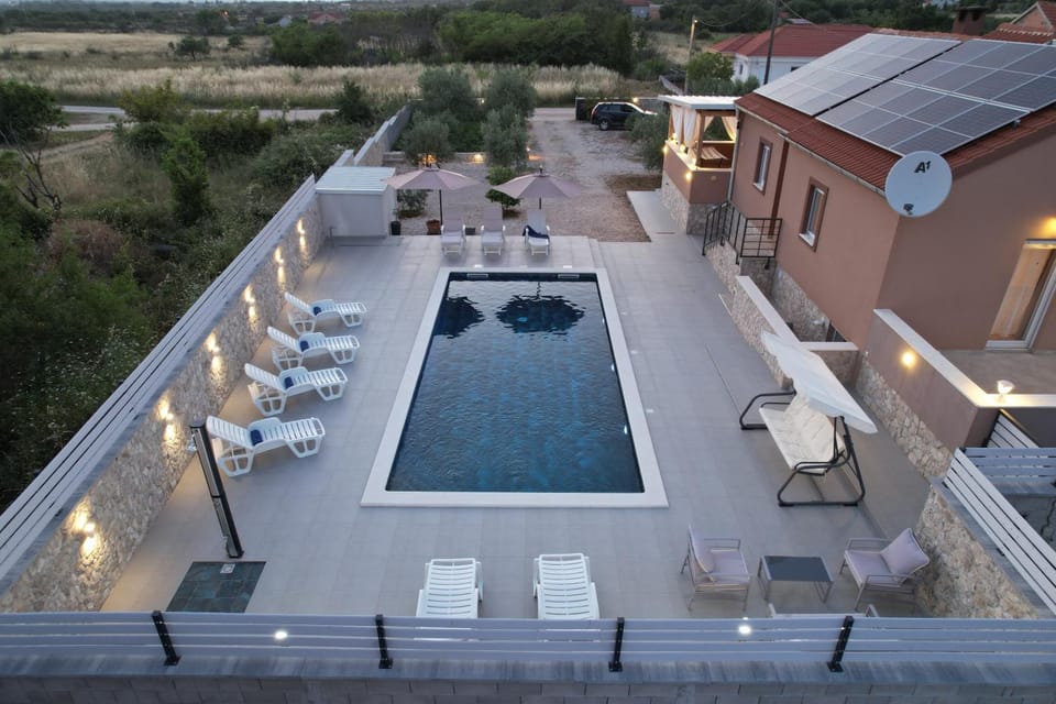 Property building, Patio, Natural landscape, Pool view, Swimming pool, sunbed