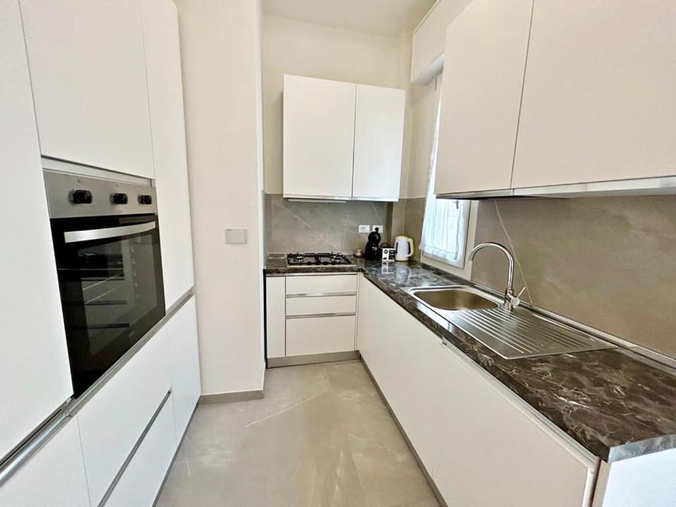Kitchen or kitchenette, dishwasher, oven, stove