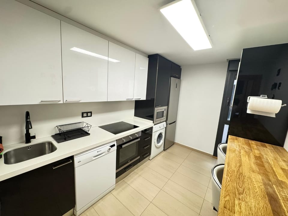 Kitchen or kitchenette, dishwasher, oven, stove