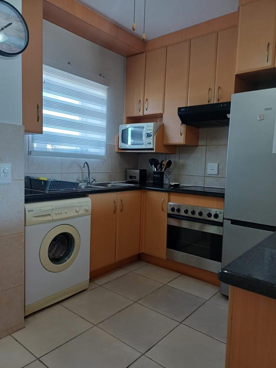 Kitchen or kitchenette, oven, stove, toaster, washing machine