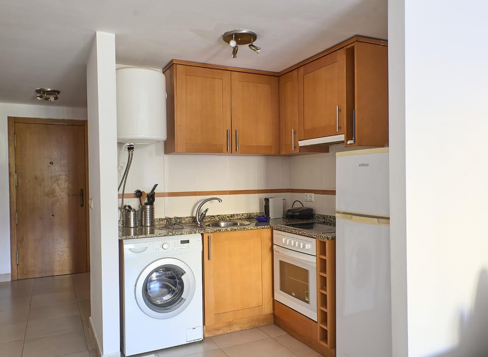 Kitchen or kitchenette, oven, stove, toaster, washing machine
