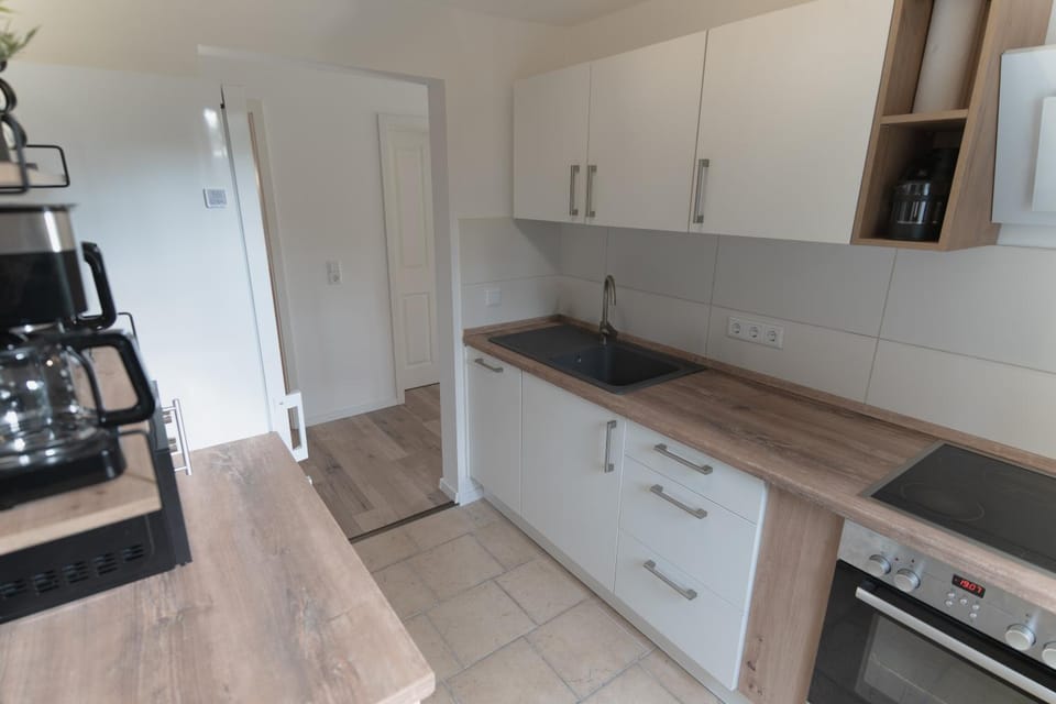 Kitchen or kitchenette, dishwasher, oven, stove