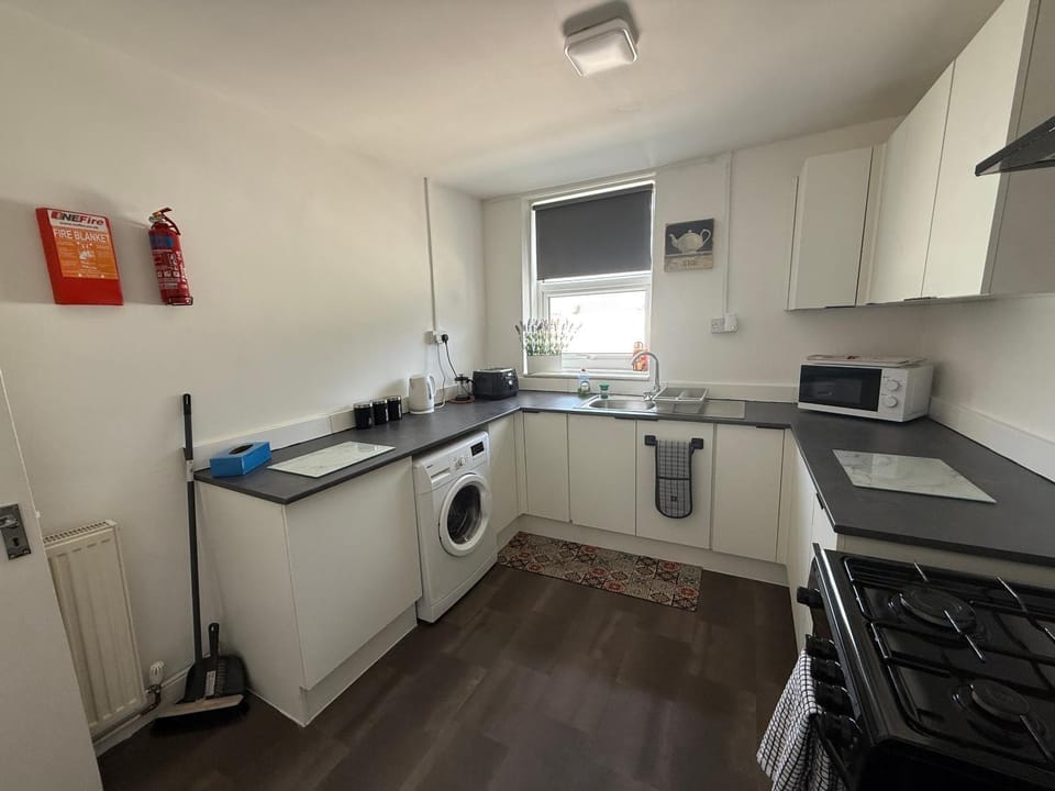 Kitchen or kitchenette, dishwasher, oven, stove, toaster
