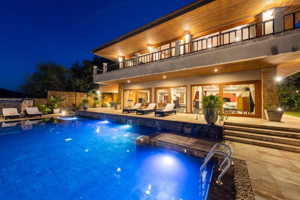 Property building, Patio, Night, Pool view, Swimming pool, Swimming pool, sunbed
