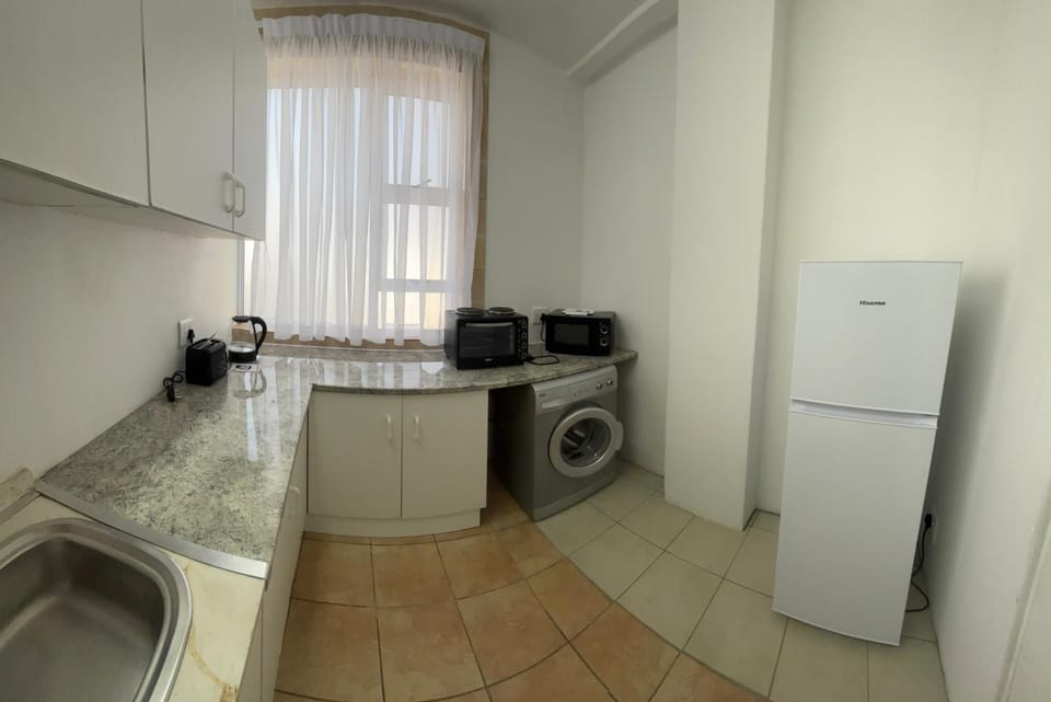 Kitchen or kitchenette, stove, toaster, washing machine