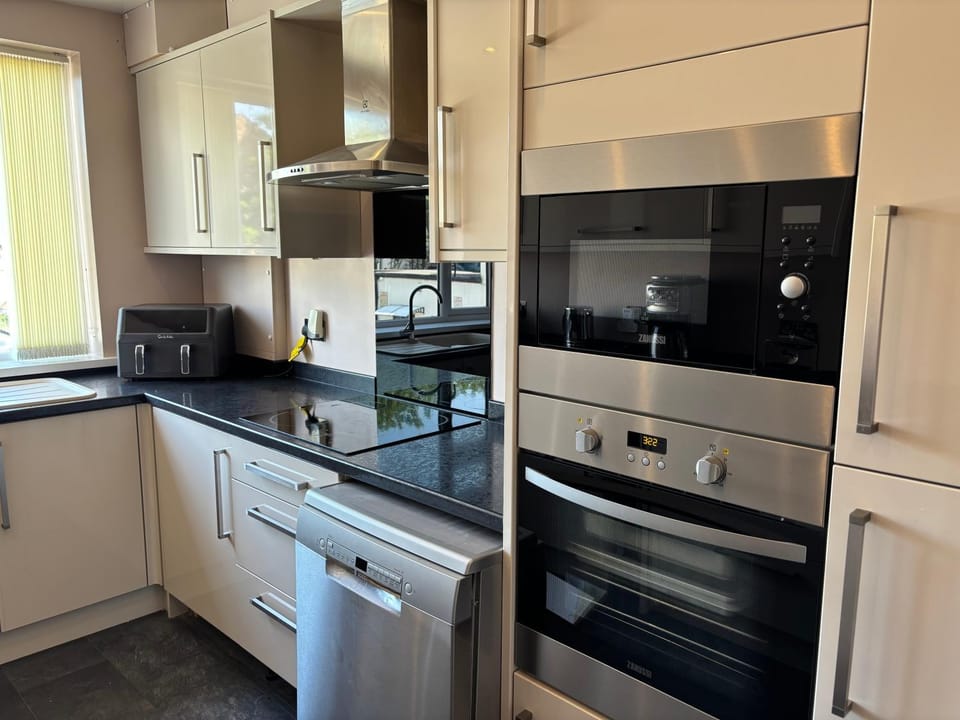 Kitchen or kitchenette, dishwasher, oven, stove