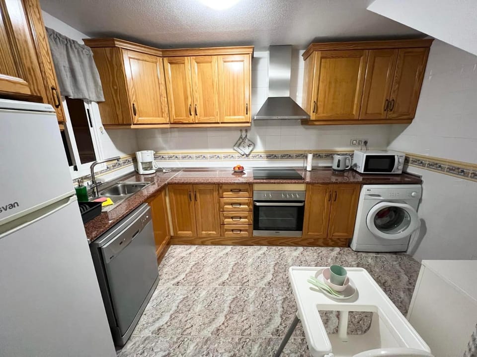 Kitchen or kitchenette, dishwasher, oven, stove, toaster, washing machine