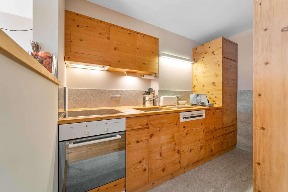 Kitchen or kitchenette, dishwasher, oven, stove