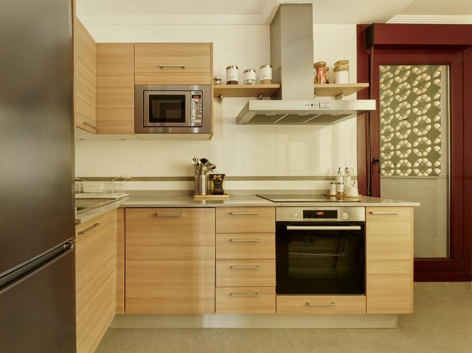 Kitchen or kitchenette, dishwasher, oven, stove
