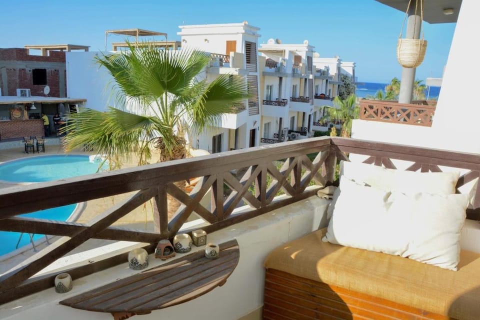 Property building, Patio, Balcony/Terrace, Seating area, Pool view, Sea view, Swimming pool