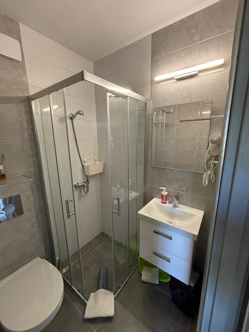Shower, Toilet, Bathroom, hair dryier, towels