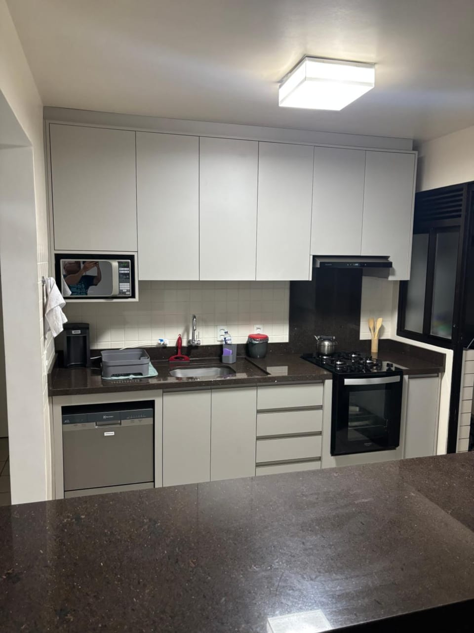 Kitchen or kitchenette, microwave, oven, stove