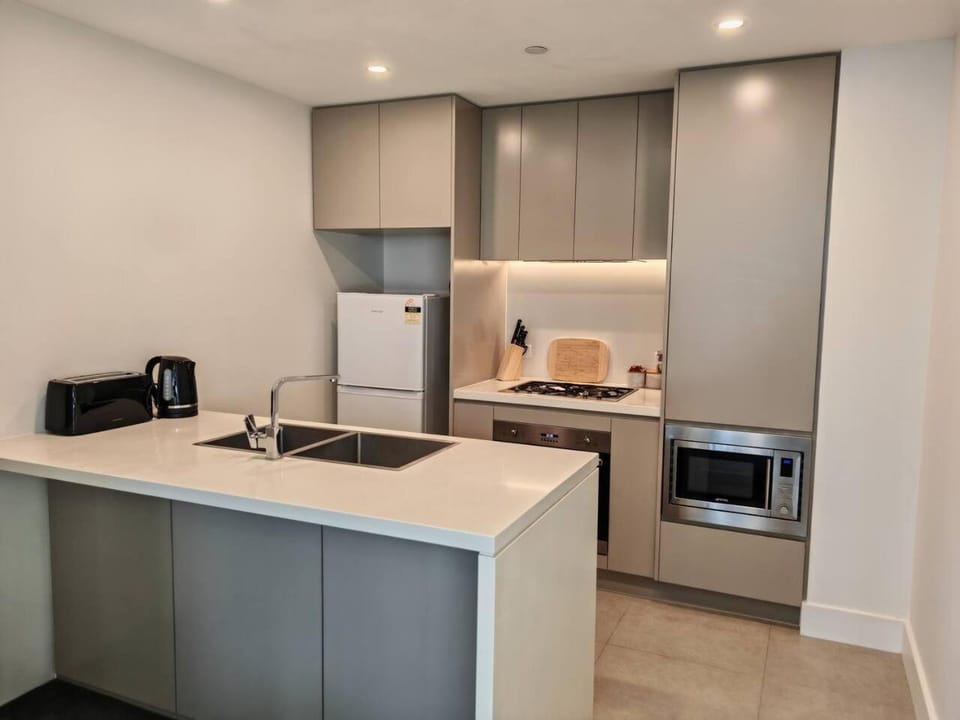 Kitchen or kitchenette, dishwasher, oven, stove