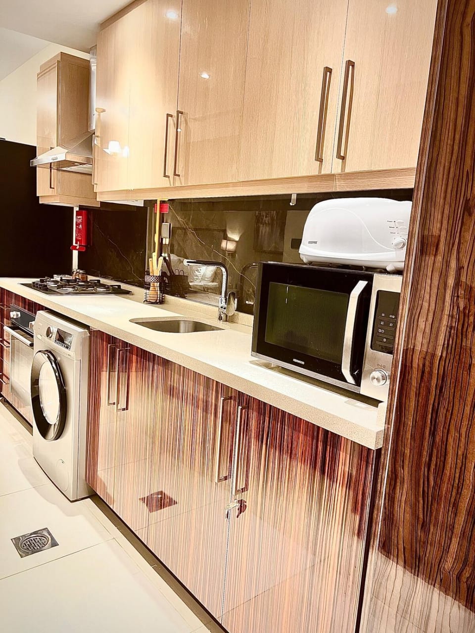 Kitchen or kitchenette, oven, stove, toaster, washing machine