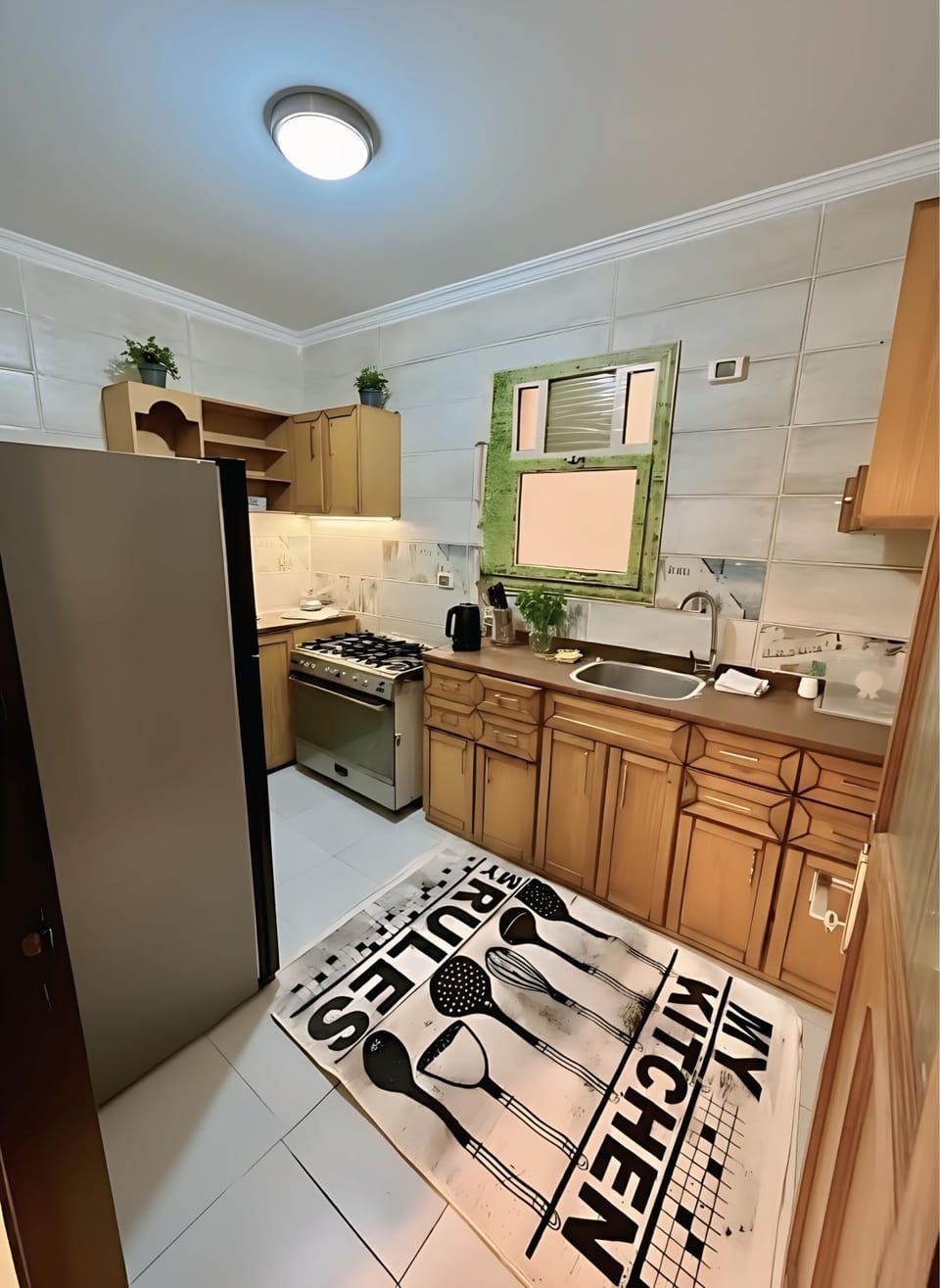 Kitchen or kitchenette, dishwasher, microwave, oven, stove