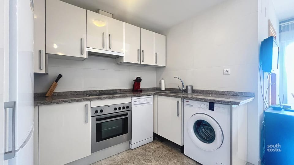 Kitchen or kitchenette, dishwasher, oven, stove, toaster, washing machine