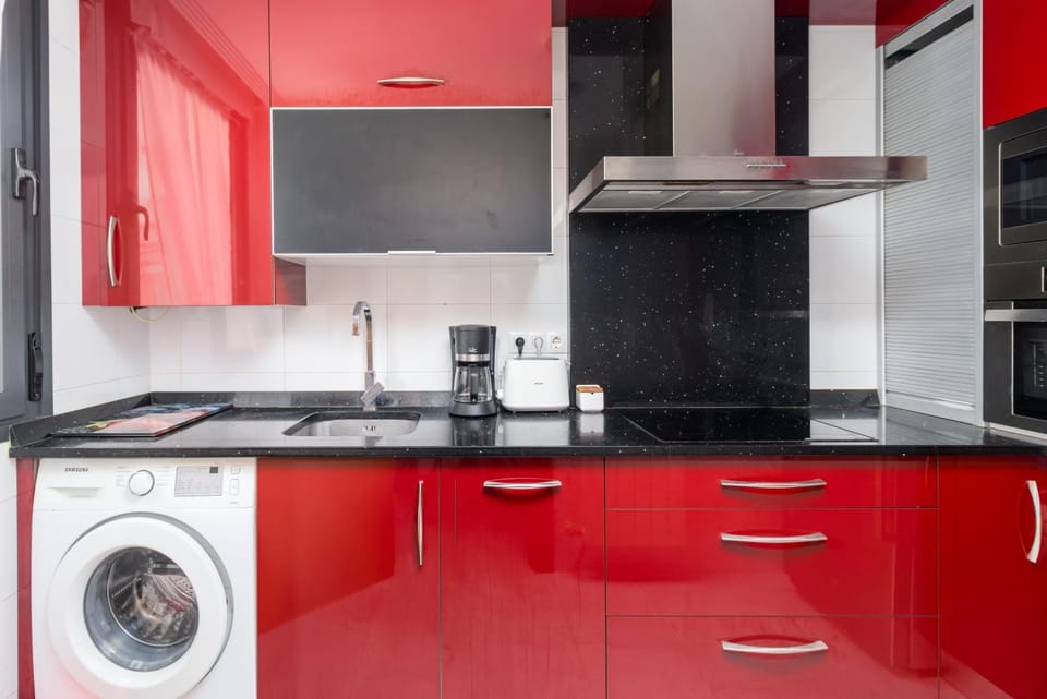 Kitchen or kitchenette, dishwasher, oven, stove, toaster, washing machine