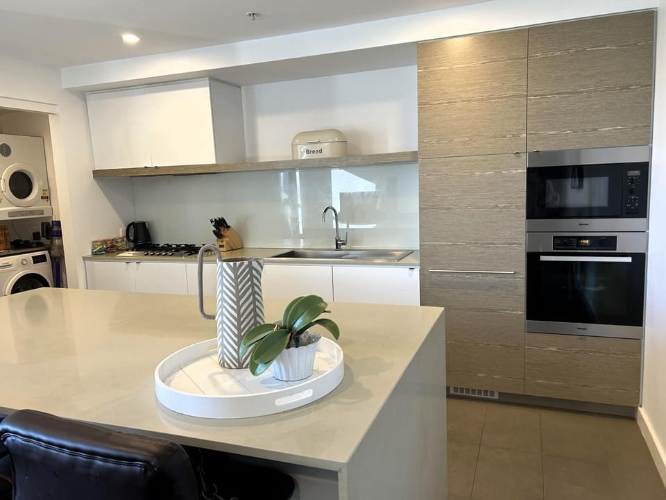 Kitchen or kitchenette, dishwasher, oven, stove, laundry