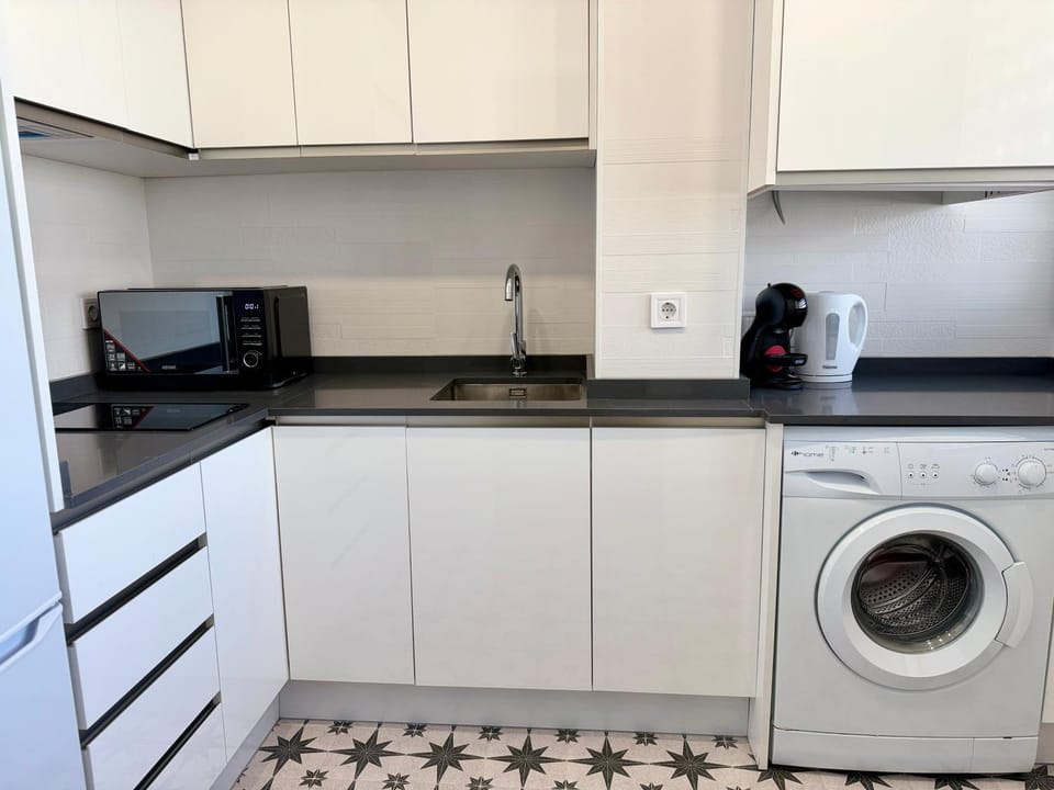 Kitchen or kitchenette, stove, washing machine