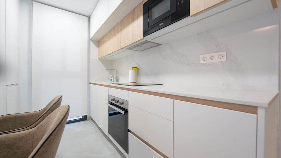 Kitchen or kitchenette, dishwasher, microwave, oven, stove