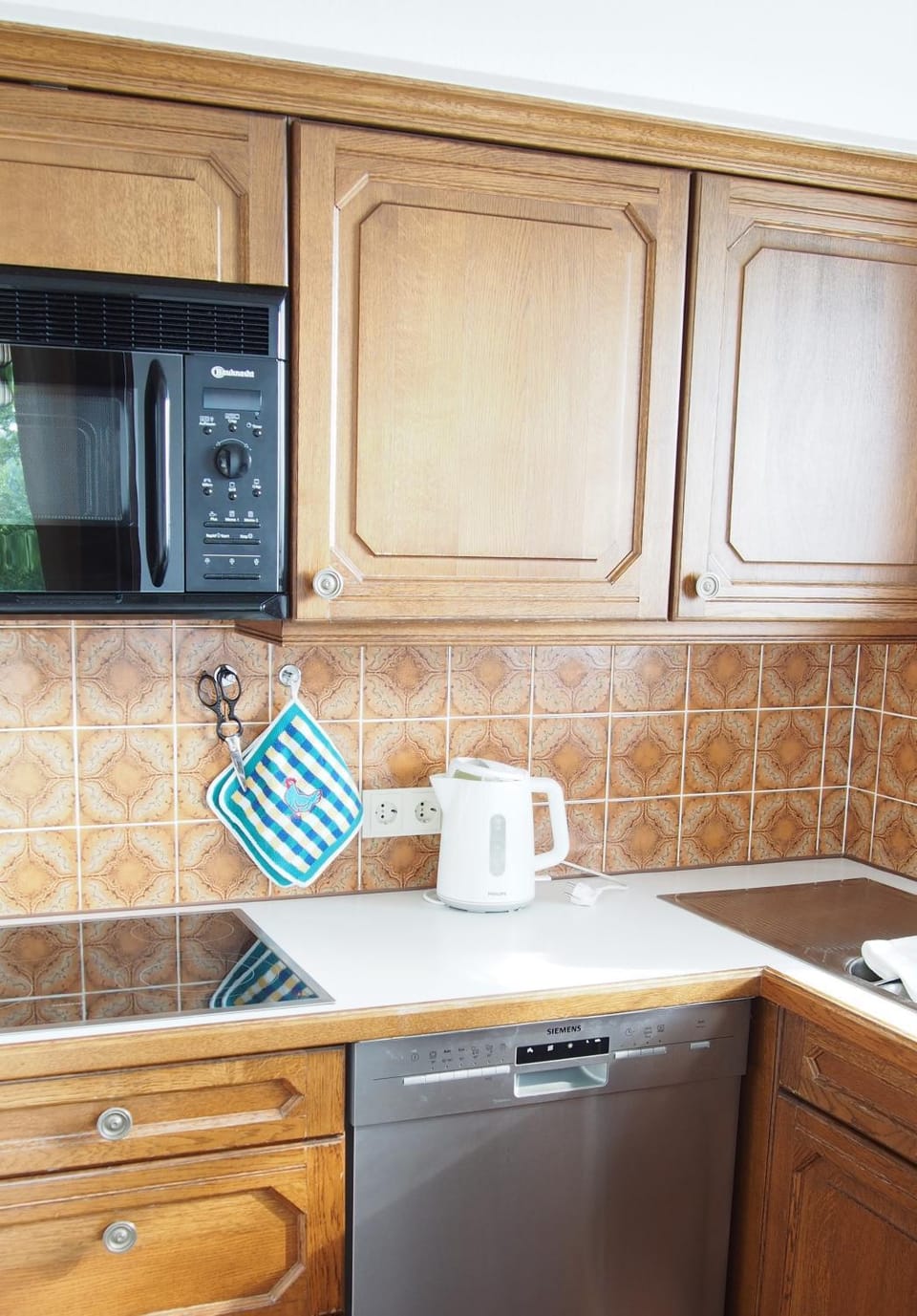 Kitchen or kitchenette, dishwasher, microwave, oven, stove