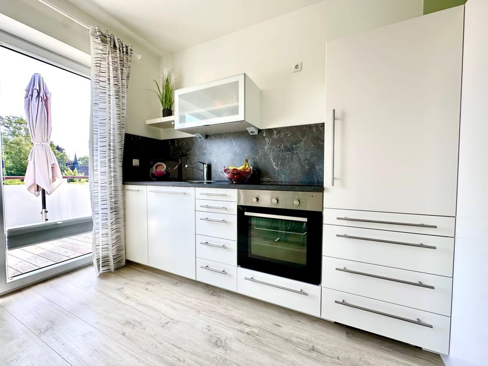 Kitchen or kitchenette, dishwasher, oven, stove