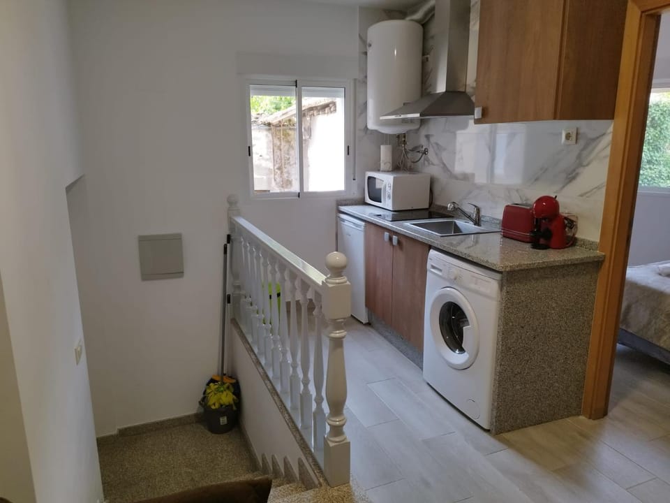 Kitchen or kitchenette, stove, toaster, washing machine