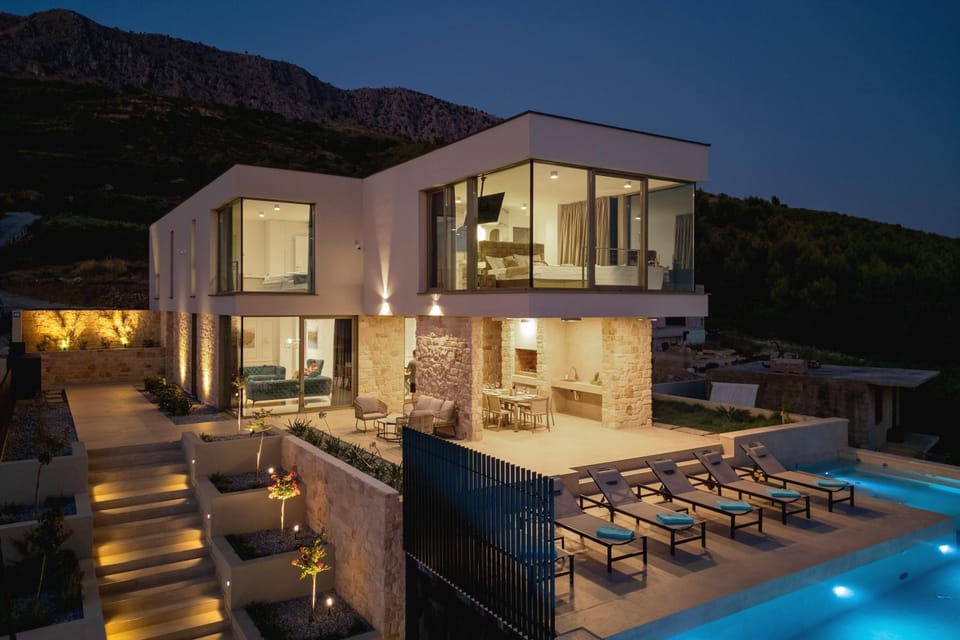 Property building, Patio, Night, Natural landscape, Balcony/Terrace, Seating area, Mountain view, Pool view, Swimming pool, sunbed