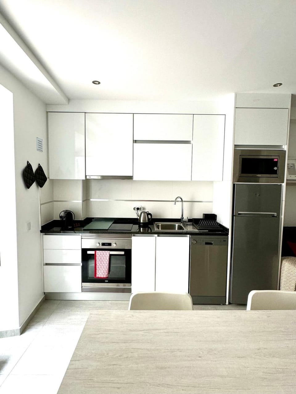 Kitchen or kitchenette, dishwasher, oven, stove