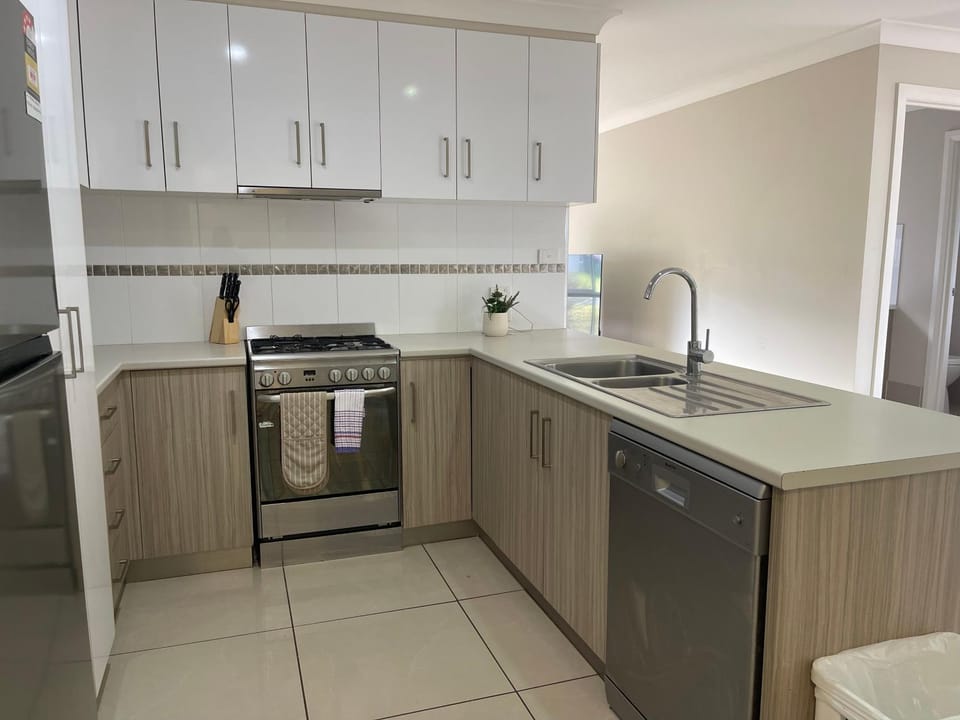 Kitchen or kitchenette, dishwasher, oven, stove