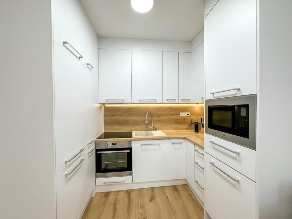 Kitchen or kitchenette, dishwasher, microwave, oven, stove